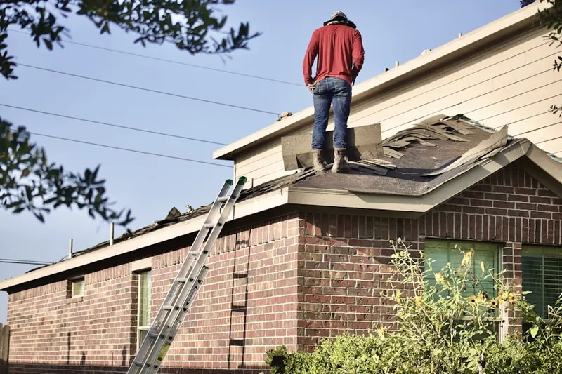 Professional roofer working on a residential roof in Burkhardt